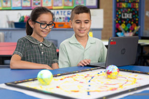 Two students painting with robotics at St Francis Xavier's Catholic Primary School Lurnea